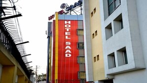 A multi-story building with a prominent red vertical sign reading "HOTEL SAAD". - Hotel Saad (Kolkata)