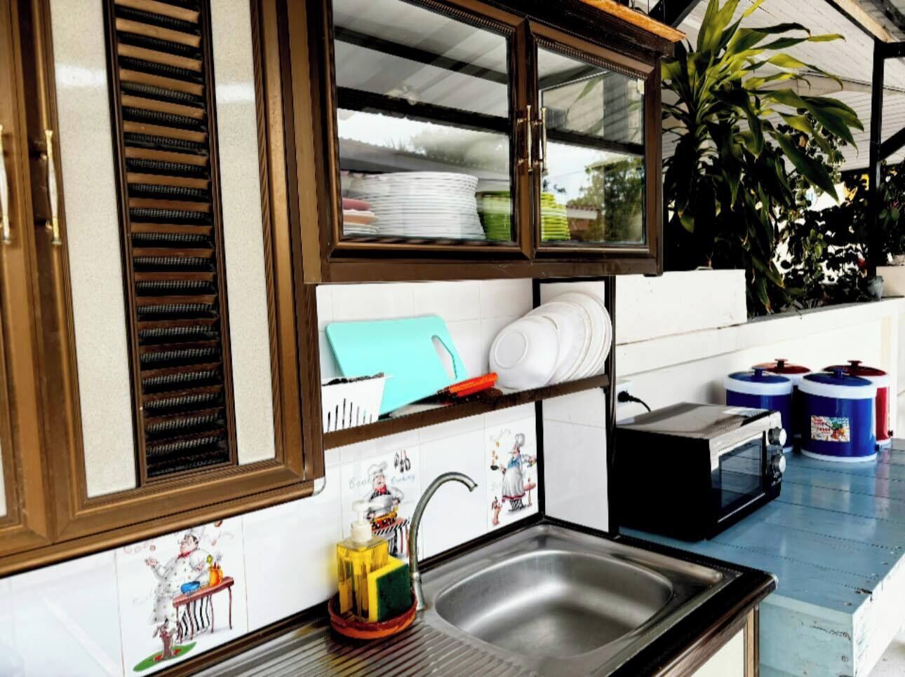 A compact kitchen with a sink, a microwave, and a small countertop.