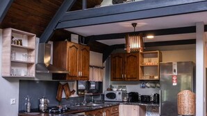 A modern kitchen with wooden cabinetry, a central island, and stainless steel appliances. - VivaHill Sapanca (Sapanca)
