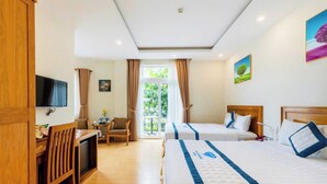 A hotel room with two beds, a desk, a TV, and a balcony with curtains. - Blue Diamond Airport Hotel (Ho Chi Minh City)
