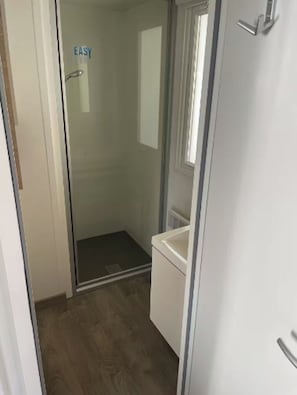 Shower, hair dryer, soap, toilet paper