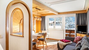 A cozy living room with a wooden ceiling, a dining area, and a TV. - Apartment 'Gaichtspitze - 8' with Mountain View, Private Balcony and Wi-Fi (Nesselwängle)