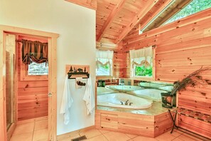 A wooden cabin bathroom with a large sink, a mirror, and a towel rack. - Luxury Vacation Rental with a Hot Tub for Rent in Clyde, North Carolina (Clyde)