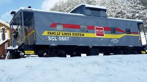 A train with 'FAMILY LINES SYSTEM' and 'SCL 0887' visible on its side. - Glamping Caboose Rental Perfect for Families near Clyde, North Carolina (Clyde)