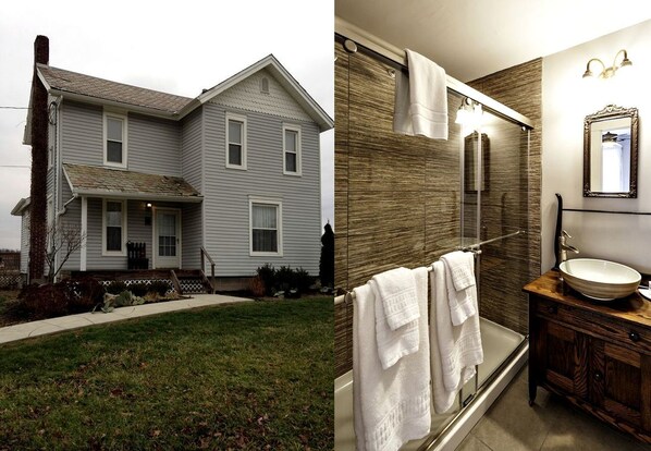 A two-story house with a porch, a bathroom with a large mirror, and a wooden vanity.