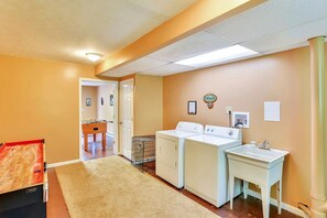 A laundry room with a washing machine, dryer, and a small sink. - Charming Cabin Rental with a Hot Tub and Fireplace in the Smoky Mountains (Clyde)