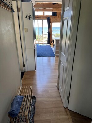 A corridor leading to a bedroom with a view of the sea. - The Eagles Nest (Ellsworth)
