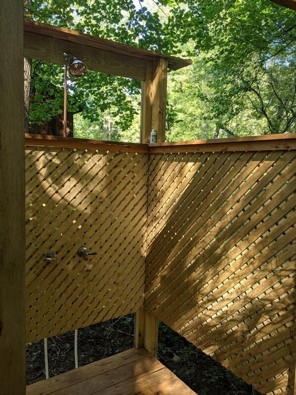 A wooden deck with a slatted design, surrounded by trees. - Charming Vacation Rental in a Barn on a Horse Farm near Afton Mountain in Virginia (Afton)