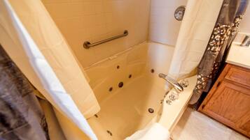 Jetted tub, hair dryer, towels, soap