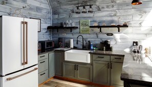 Coffee/tea maker, fridge, stovetop, cookware/dishes/utensils