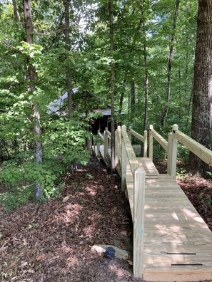 Eine Holzbrücke in bewaldetem Gebiet.