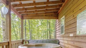 A wooden deck with a hot tub, wooden steps, and a wooden railing. - Rustic Cabin on 28-Acre Property in the Foothills of the Blue Ridge Mountains (Elkin)