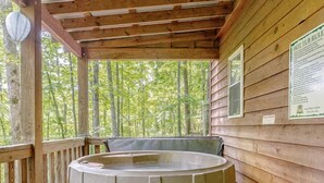 A wooden deck with a hot tub, wooden steps, and a wooden railing. - Rustic Cabin on 28-Acre Property in the Foothills of the Blue Ridge Mountains (Elkin)