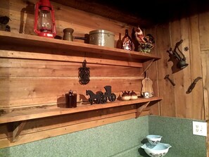 Wooden shelves with various kitchen items, a red lantern, and a small horse figurine. - Cozy Vacation Rental with High-Speed Wi-Fi near Seven Springs, Pennsylvania (Champion)