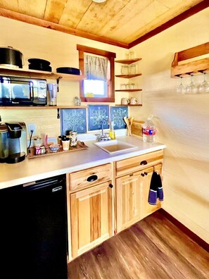 Fridge, microwave, coffee/tea maker, cookware/dishes/utensils