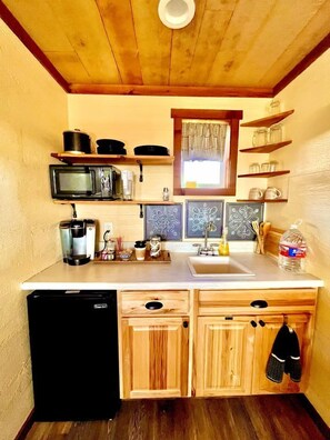 Fridge, microwave, coffee/tea maker, cookware/dishes/utensils