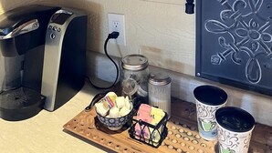 A kitchen with a microwave, toaster, and various kitchen items on shelves. - Peaceful Texas Hill Country Rental Perfect for Glamping Around Austin (Dripping Springs)