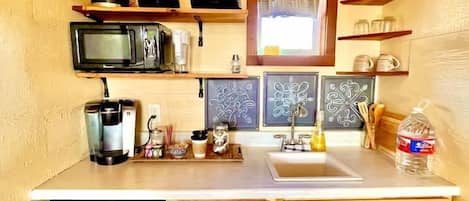 Fridge, microwave, coffee/tea maker, cookware/dishes/utensils