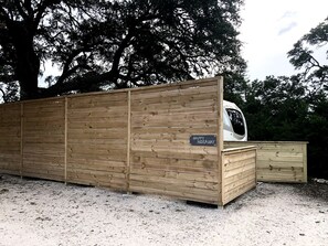 A wooden cabin with a sign reading 'HAPPY HIDEAWAY.'