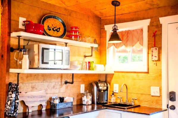 Coffee/tea maker, fridge, microwave, dining tables