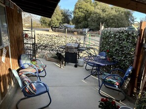 A patio with outdoor furniture, a grill, and a dog. - Charming Warner Springs Accommodation Ideal for a Romantic Getaway in California (Warner Springs)