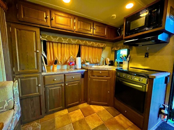 Fridge, stovetop, coffee/tea maker, cookware/dishes/utensils