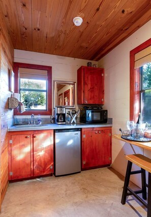 Fridge, microwave, coffee/tea maker, cookware/dishes/utensils