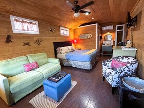 A cozy room with a sofa, a bed, a chair, and a small table. - Gorgeous Texas Hill Country Rental near Austin for a Relaxing Getaway in Texas (Dripping Springs)