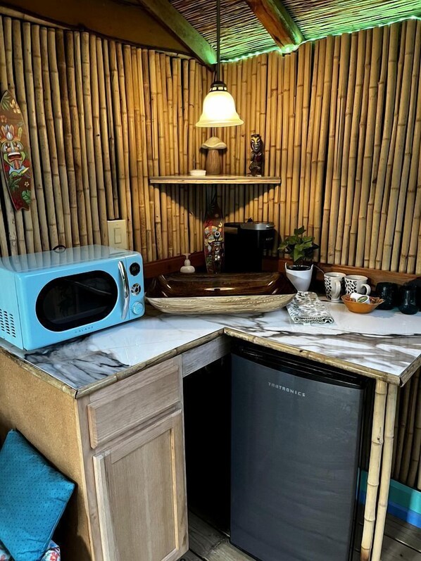 A compact kitchen with a microwave, coffee maker, and a dishwasher.
