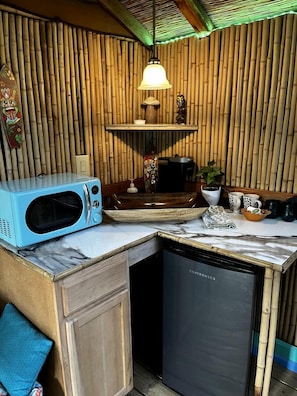 A compact kitchen with a microwave, coffee maker, and a dishwasher.