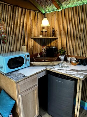 A compact kitchen with a microwave, coffee maker, and a dishwasher. - Unique Bamboo Tree House for an Unforgettable Couples Getaway by Lake Conroe, Texas (Willis)