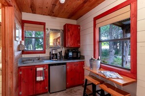 Fridge, microwave, coffee/tea maker, cookware/dishes/utensils