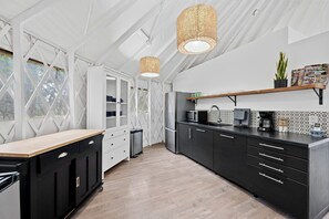 Fridge, dishwasher, coffee/tea maker, cookware/dishes/utensils