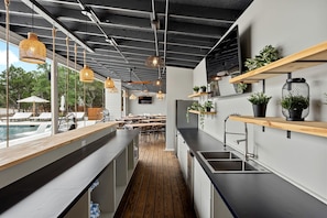 A modern kitchen with wooden countertops, hanging pendant lights, and potted plants. - A Romantic Getaway in this Luxurious Yurt for Couples in Wimberley, TX (Wimberley)