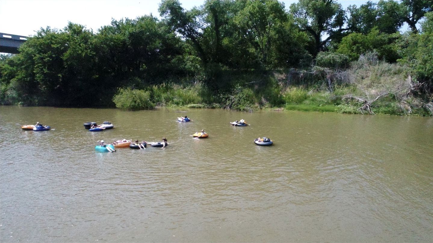 A river with several small boats floating on the water.