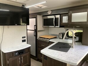 Fridge, stovetop, coffee/tea maker, cookware/dishes/utensils