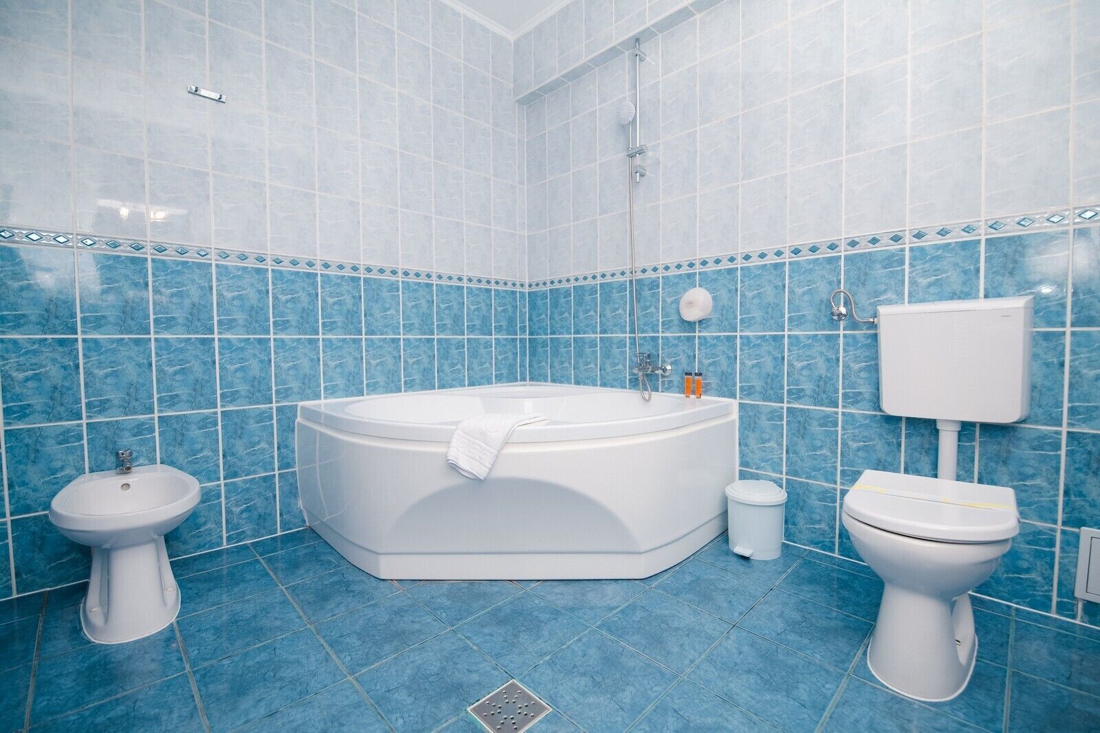 A bathroom with a bathtub, a sink, a toilet, and a shower.