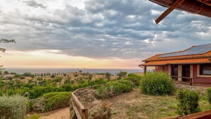 A coastal view with a wooden deck, a building with a red roof, and a path leading to the sea. - Tenuta dell'Argento - Room 7 by Rentbeat (Civitavecchia)