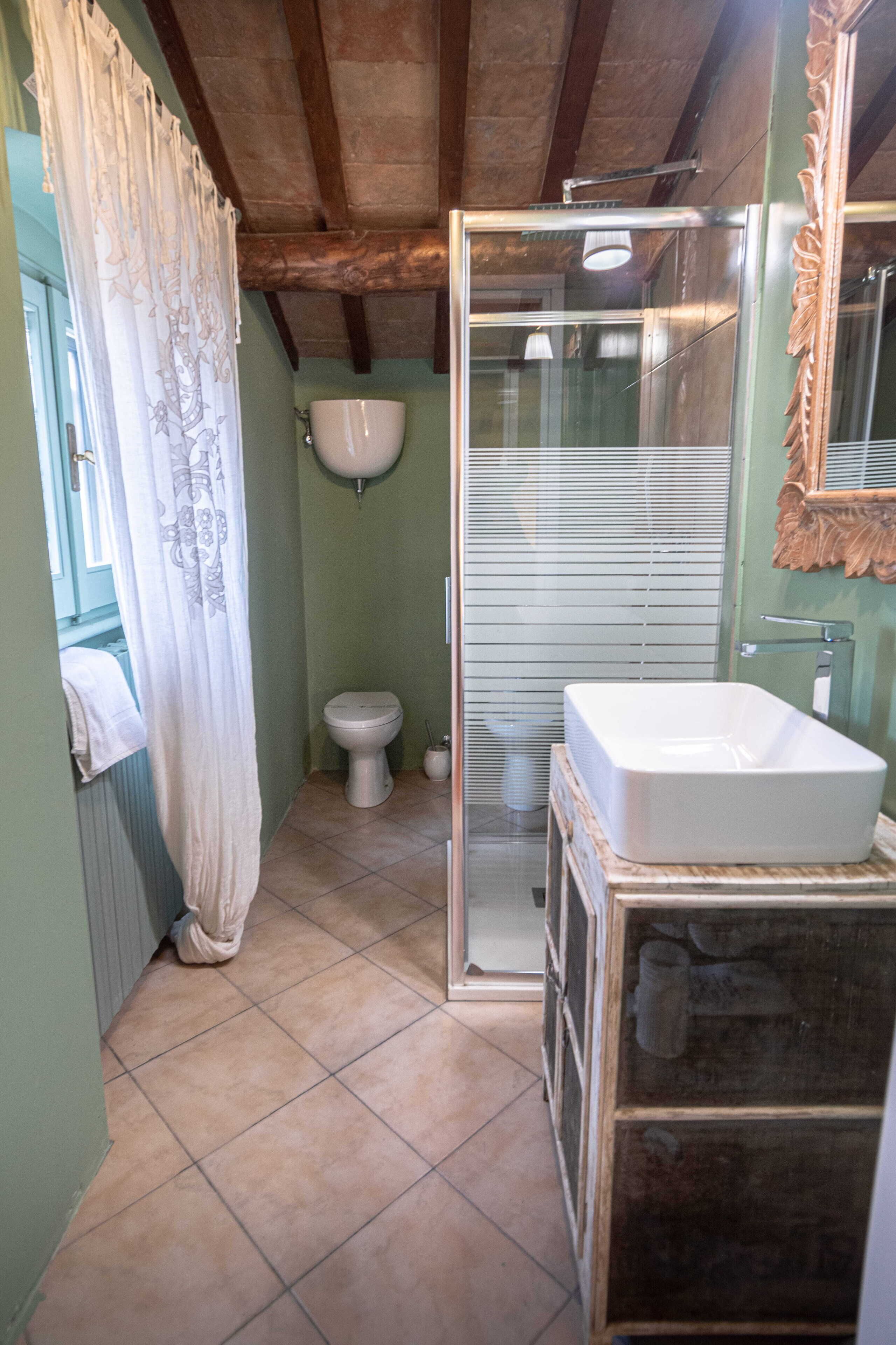 A bathroom with a shower, toilet, and sink.