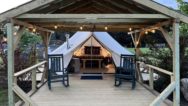 A wooden gazebo with a tent interior, two chairs, and a bench. - Adult Only Bell Tent Perfect for a Romantic Getaway in Turner, Maine (Turner)