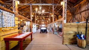 A spacious hall with wooden beams, a central table, and a rustic ambiance. - Adult Only Bell Tent Perfect for a Romantic Getaway in Turner, Maine (Turner)