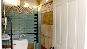 A bathroom with a toilet, sink, shower, and a door. - Roan Mountain Glamping Yurt, Ideal to Hike the Appalachian Trail (Roan Mountain)