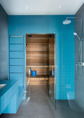 A modern bathroom with a shower, a glass-enclosed toilet, and a wooden vanity. - Sky House Boutique Seaside Retreat With Cinema Near Dillon Beach (Dillon Beach)