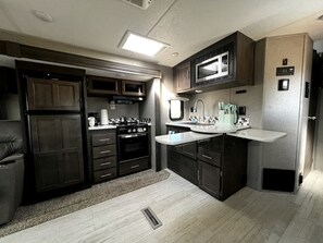 Coffee/tea maker, fridge, oven, stovetop - Spacious Camper on a Llama Rescue Ranch with Stunning Views near Questa, New Mexico (Questa)