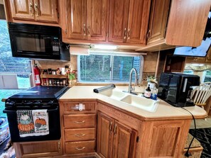 Fridge, microwave, stovetop, coffee/tea maker
