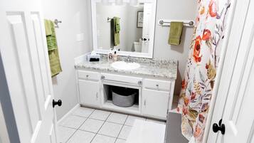 Jetted bath, hair dryer, towels, toilet paper