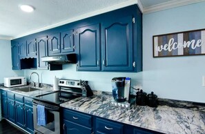 Fridge, stovetop, coffee/tea maker, cookware/dishes/utensils