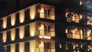 A multi-story building with illuminated signage reading "SAI RESIDENCY" and "SAI RESIDENCE HOTEL". - Hotel Sai Residency (Pune)