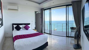 A modern hotel room with a large bed, a view of the sea, and a balcony with a chair. - Astoria Villa #2 – 3 Bed Pool Villa in Koh Samui (Chang Wat Surat Thani)