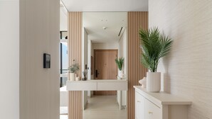 A modern kitchen with a central island, wooden paneling on the walls, and a potted plant on the counter. - Binghatti Onyx - 3112 2BD (Dubai)